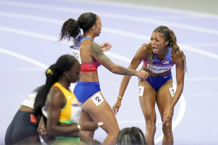 Florence’s Gabby Thomas, right, reacts after winning the women's 200-meters final at the 2024 Summer Olympics, Tuesday, Aug. 6, 2024, in Saint-Denis, France. 