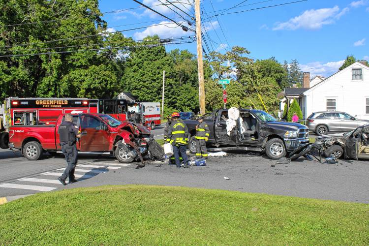Police and firefighters respond to the intersection of Country Club Road, Silver Street and Vernon Street in Greenfield on Friday afternoon following a three-vehicle collision.
