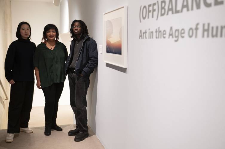 From left, Bo Kim, Eva Barajas and Adeyemi Adebayo, curators of the show “(Off)Balance: Art in the Age of Human Impact,” at the University Museum of Contemporary Art at UMass Amherst.