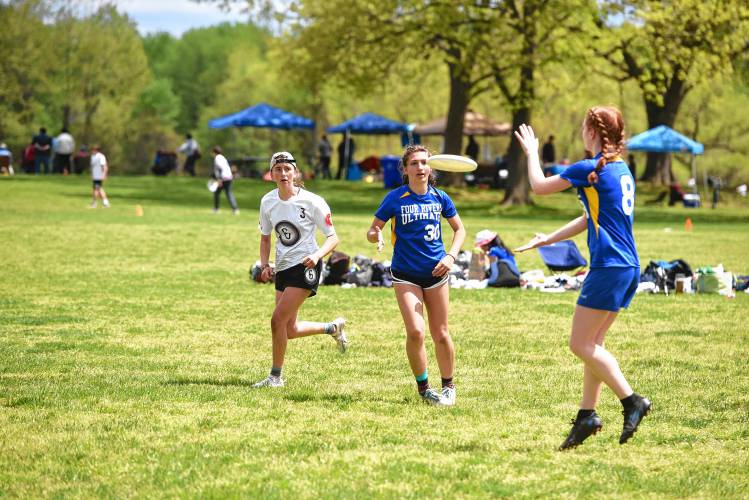 Four Rivers’ Hazel Bird Richards (30) passes to Sylvia Guillaume (8) during a game against Cumberland in the Four Rivers Ultimate Tournament in Greenfield Saturday.
