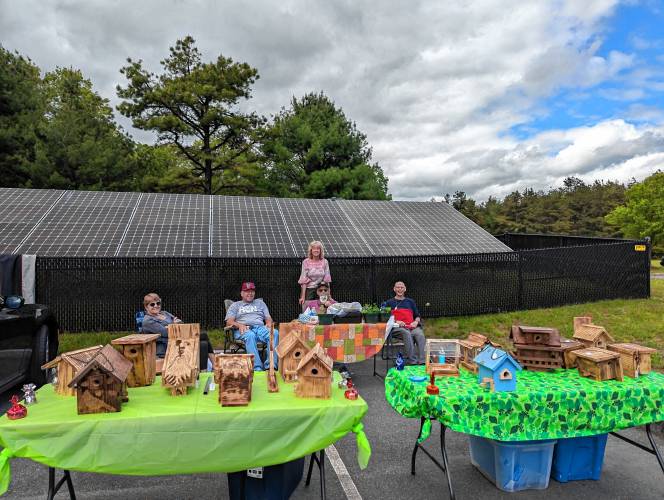 Erving residents sell their wares on Sunday, May 19, as part of Sculpture Fest, a celebratory event to unveil a new natural materials sculpture at the Erving Public Library.