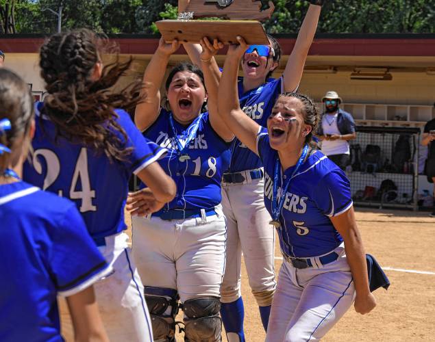 Turners Falls captains Madi Liimatainen (5), Holly Myers (18) and Mia Marigliano hold up the state title trophy following the Thunder’s 5-0 win over Georgetown in the MIAA Division 5 championship game on Saturday at Sortino Field on the campus of UMass.