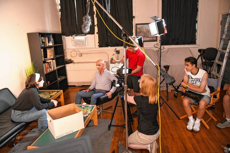 Actors Cynthia Lupo and John Basile with crew members Ben Roberts and Emily Laus and Director Connor Mabius in a scene from “Averted,” which is being filmed in part at Frontier Community Access Television  (FCAT)’s studios in the Sunderland Town Offices.