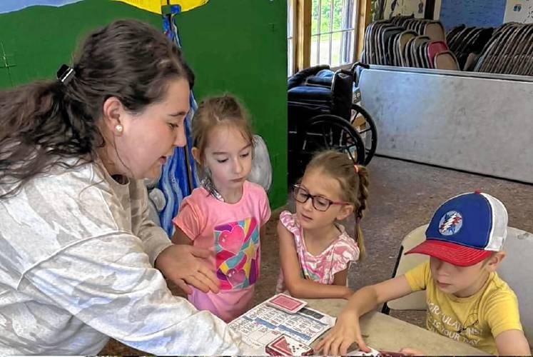 Guest instructor Hanna Fitzpatrick plays card games with Camp Kee-wanee children.