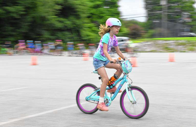 Children ride their bikes by a radar detector to clock their speed during a bicycle rodeo at Northfield Elementary School on Wednesday sponsored by the Northfield Recreation Commission’s Summer Program.
