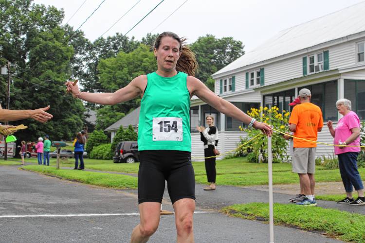 Anna Zilinski crossing the finish line, winning the overall women's race of the 43rd Montague Mug Race with a time of 33 minutes and 44 seconds. 
