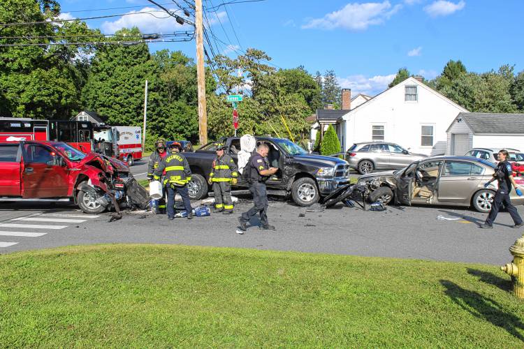 Police and firefighters respond to the intersection of Country Club Road, Silver Street and Vernon Street in Greenfield on Friday afternoon following a three-vehicle collision.