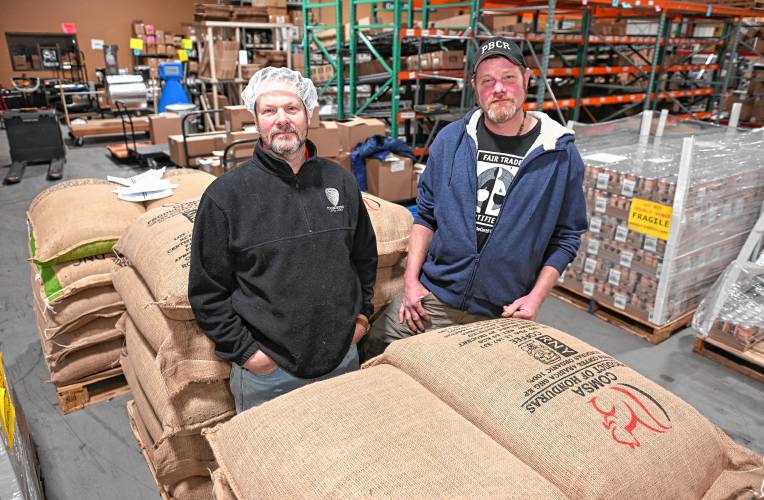 Sean and Darren Pierce of Fogbuster Coffee Works in Greenfield with freshly delivered bags of fair trade organic green coffee beans.