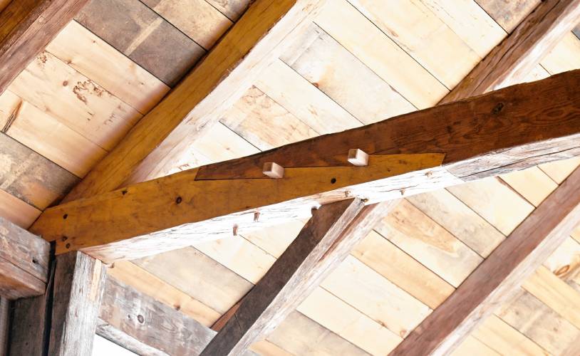 A stop-splayed, under-squinted scarf joint with double wedges joins an original beam with new material in the rebuilt barn at the Wilder Homestead in Buckland.