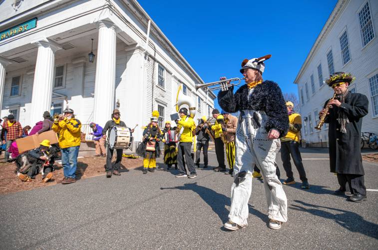 Kris Richardson plays the trumpet while dressed as a cow with the Expandable Brass Band during  an “Attack on Small Farms” rally Sunday in front of Hadley Town Hall. 