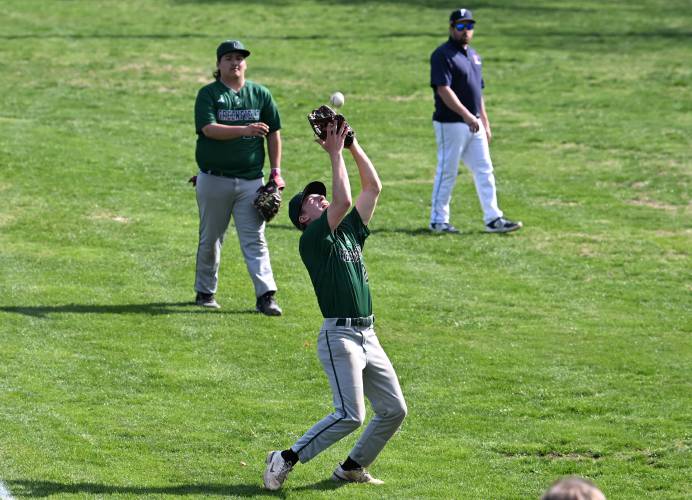 Greenfield’s Logan Moore pulls in a foul ball as first baseman Urijah Jenness watches from behind at Veterans Field in Greenfield on Thursday. 