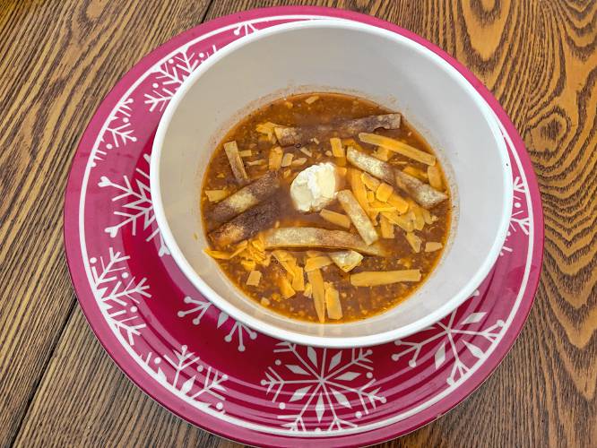 The soup was a huge hit when I took it to a pot luck. When I ate leftovers by myself, I eschewed the garnishes. My friends found them delightful, however. Happily, the sour cream managed to tone down the spice factor for anyone who objected to heat.