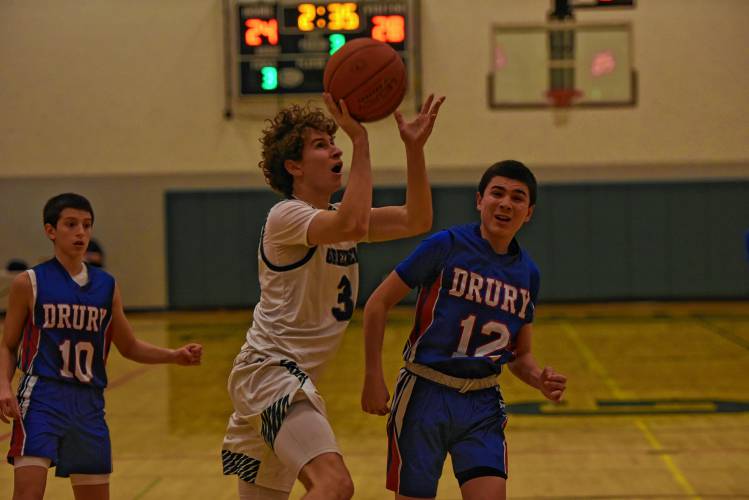Greenfield’s Ollie Postera (3) goes in for a shot against Drury during the Green Wave’s Hampshire League South victory on Monday night at Nichols Gymnasium in Greenfield.
