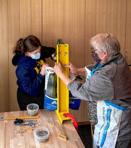 Greening Greenfield hosted a workshop on using empty bags of animal feed to make reusable shopping bags at the Greenfield Public Library Makerspace on Saturday.