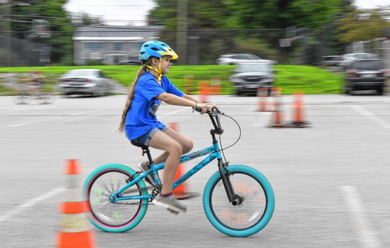 Children ride their bikes by a radar detector to clock their speed during a bicycle rodeo at Northfield Elementary School on Wednesday sponsored by the Northfield Recreation Commission’s Summer Program.