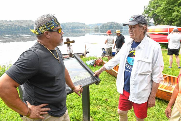 Jose “Ite” Santana of the Chaubunagungamaug Band of Nipmuc talks with Nolumbeka Project President David Brule just prior to the Peskeompskut Paddle on Friday at Barton Cove. 