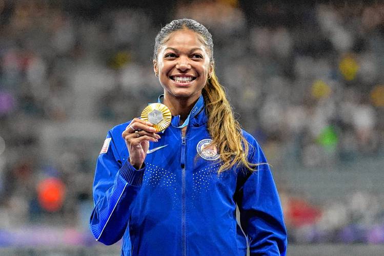 Florence’s Gabby Thomas stands on the podium after winning gold in the women's 200-meter at the 2024 Summer Olympics, Wednesday in Saint-Denis, France.