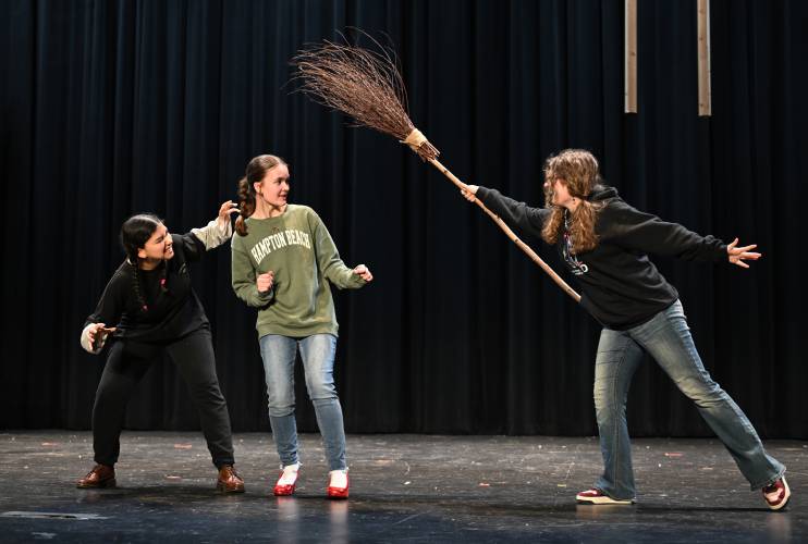 Rachel Montemor as Nikko (leader of the flying monkeys), Arabella Malo as Dorothy and Abby Parsons as the Wicked Witch rehearse a scene from Ralph C. Mahar Regional School’s production of “The Wizard of Oz.”