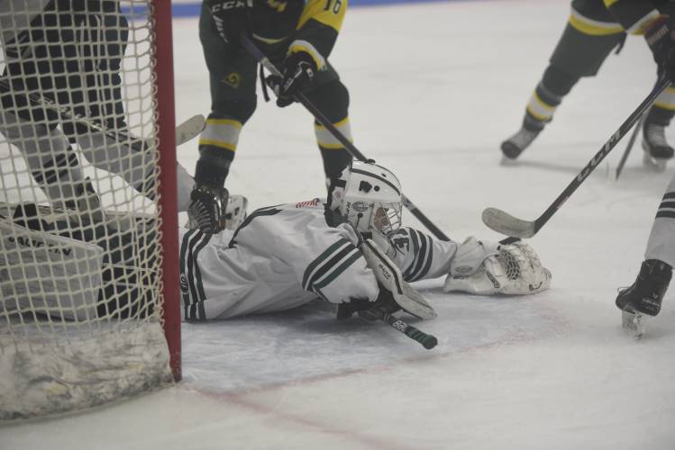 Greenfield goalie Cooper Smith dives to cover the puck against Southwick on Monday at Collins-Moylan. 
