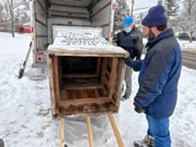The historic guideboard on the Shutesbury town common gets loaded into a truck for trip to a Williamstown conservator.