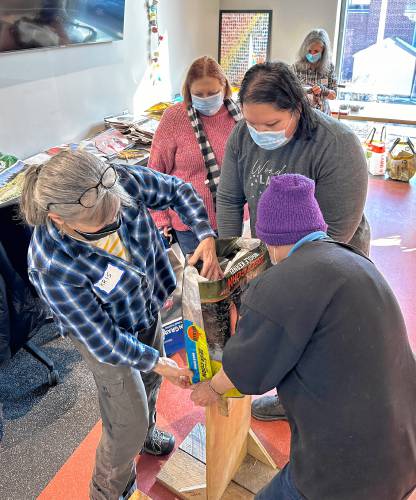 Greening Greenfield hosted a workshop on using empty bags of animal feed to make reusable shopping bags at the Greenfield Public Library Makerspace on Saturday.