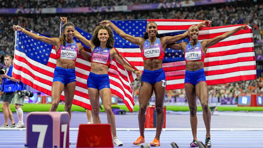 Gabby Thomas, Sydney McLaughlin-Levrone, Alexis Holmes and Shamier Little, of the United States, pose after winning the gold medal in the women's 4x400 meter relay final at the 2024 Summer Olympics, Saturday in Saint-Denis, France.