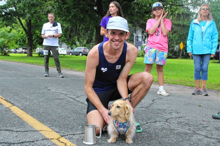 43rd Montague Mug Race overall winner Michael Keebler of Montague with his pewter mug and mini dachshund, Yoshi. 