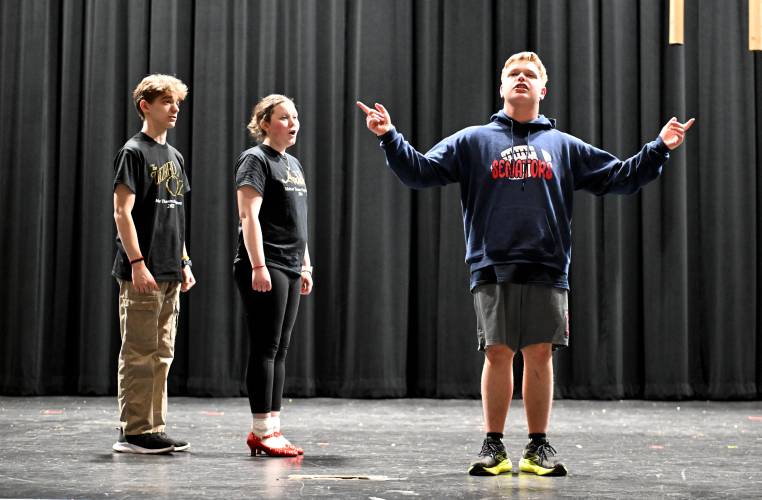 Evan Priscitello as the Scarecrow, Audrey Elwood as Dorothy and Riley Murphy as the Cowardly Lion rehearse for Ralph C. Mahar Regional School’s production of “The Wizard of Oz.”