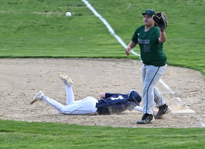 Frontier’s Shawn Baumann dives back to first on a pick off attempt as Greenfield first baseman Urijah Jenness handles the throw at Veterans Field in Greenfield on Thursday. 
