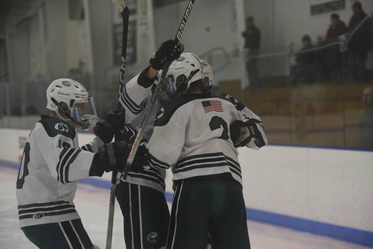 Greenfield teammates celebrate around Jake Jurek (2) following his third period goal against Southwick on Monday at Collins-Moylan. 