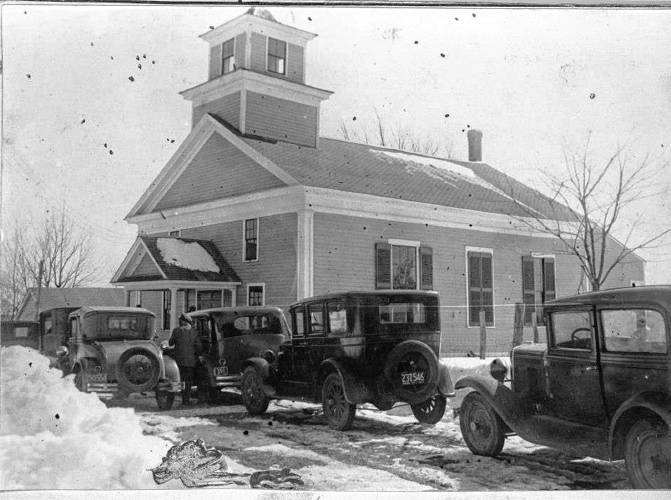 Cars are seen outside Wendell Town Hall as citizens arrive for the 1931 Wendell Town Meeting.