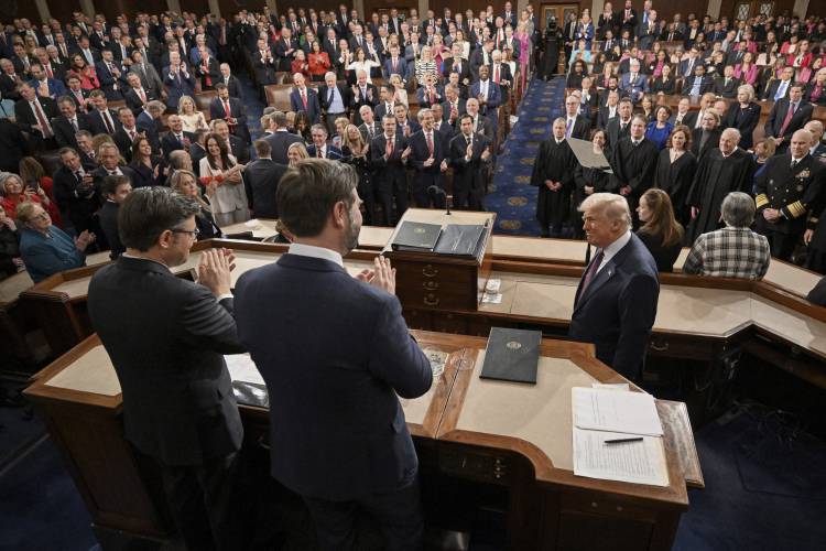 Vice President JD Vance, center, and Speaker of the House Mike Johnson, R-La., left, clap as President Donald Trump, right, arrives to address a joint session of Congress at the Capitol in Washington, Tuesday, March 4, 2025. (Mandel Ngan/Pool Photo via AP)