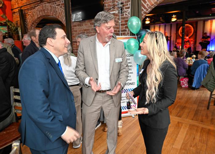 Greenfield attorney and Garden Cinemas co-owner Isaac Mass, Greenfield Savings Bank President and CEO Thomas Meshako, and Franklin County Chamber of Commerce Executive Director Jessye Deane talk during the Y’s fundraising campaign kickoff at Hawks & Reed Performing Arts Center on Thursday.