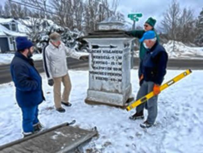 Preparations begin to load the historic guideboard on the Shutesbury town common for trip to a Williamstown conservator.