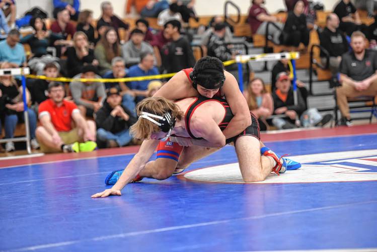Athol’s Aiden Kirwan (bottom) competes against Ashland’s Adrian Guzman in the championship match at 157 of the MIAA Div. 3 Central Mass. Championship at Ashland High School on Saturday.  