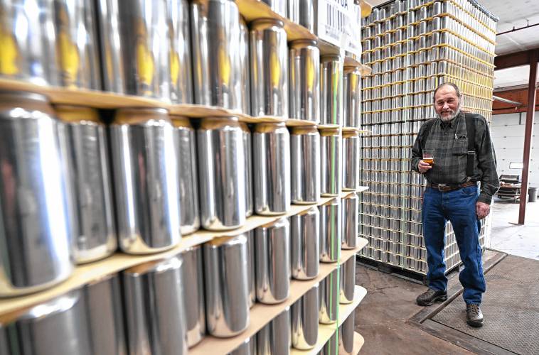 Gary Bogoff, of Berkshire Brewing Co. in South Deerfield, on the loading dock with pallets of empty aluminum cans, known in the industry as brites.
