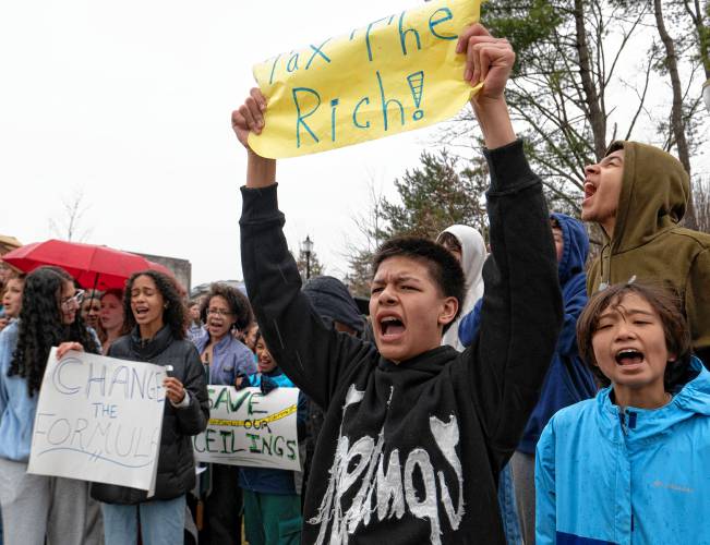 Dega Krouch, a Amherst Regional Middle School student, stands with others during a protest outside the UMass Campus Center where a hearing of the Joint Committee on Ways and Means took place on Monday. 