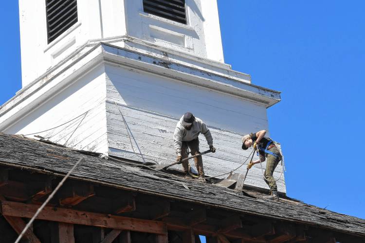 Workers from Carter & Stevens Farm LLC in Barre begin to remove the roof from the former Zion Korean Church on Main Street in Greenfield on Thursday.
