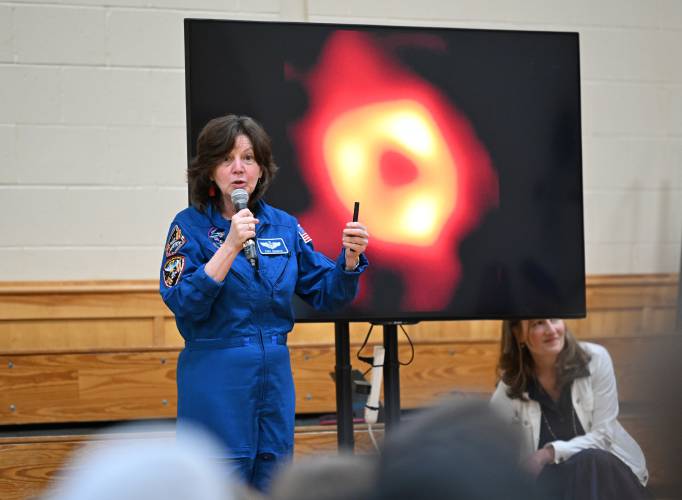 Cady Coleman of Shelburne, a former NASA astronaut, talks at a ceremony highlighting the school’s efforts to bring a Moon Tree to the school. This is a picture of a black hole taken with the telescope that was delivered in the payload of the space shuttle she was a crew member on.
