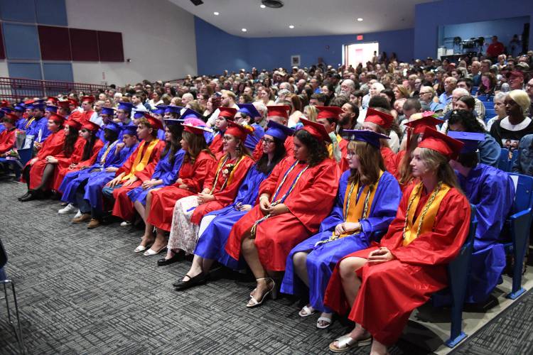 Seniors listen to speakers at commencement exercises at Ralph C. Mahar Regional School Friday evening.