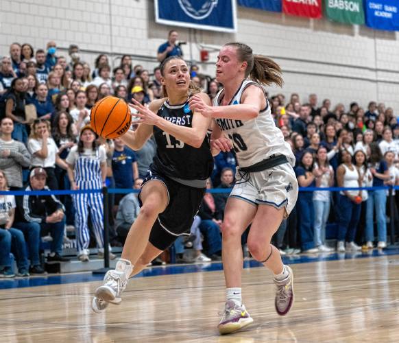 Amherst guard Laura Mendell, left, attempts to dribble around Smith guard Maggie Fleming, right, during the NCAA Division 3 Women's Basketball tournament Round of 32 game at Ainsworth Gym, Saturday.