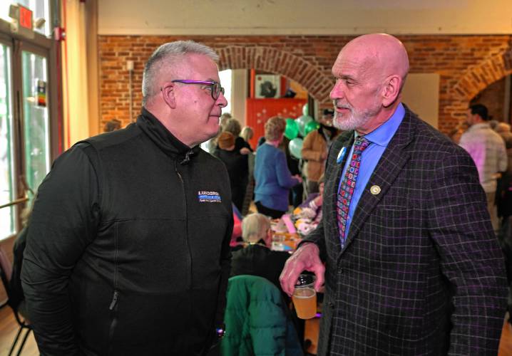 Tony Isotta of Lundgren Honda of Greenfield speaks with Franklin County’s YMCA CEO Grady Vigneau during the Y’s fundraising campaign kickoff at Hawks & Reed Performing Arts Center in Greenfield on Thursday.