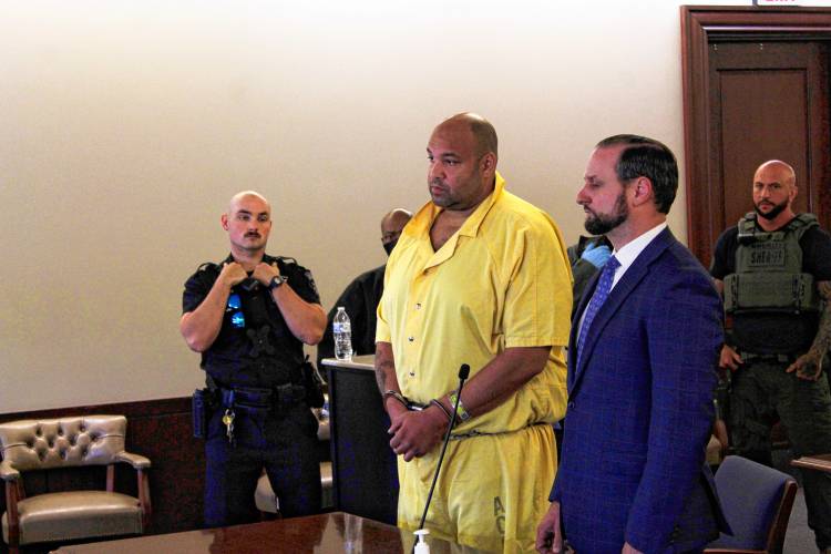 Greenfield murder suspect Taaniel Herberger-Brown, surrounded by Albany County Sheriff’s Office staff, appears before Judge William Little at Albany County Court.