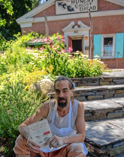 Jonathan Stevens with his “Hungry Ghost Bread Book” at the bakery in Northampton.