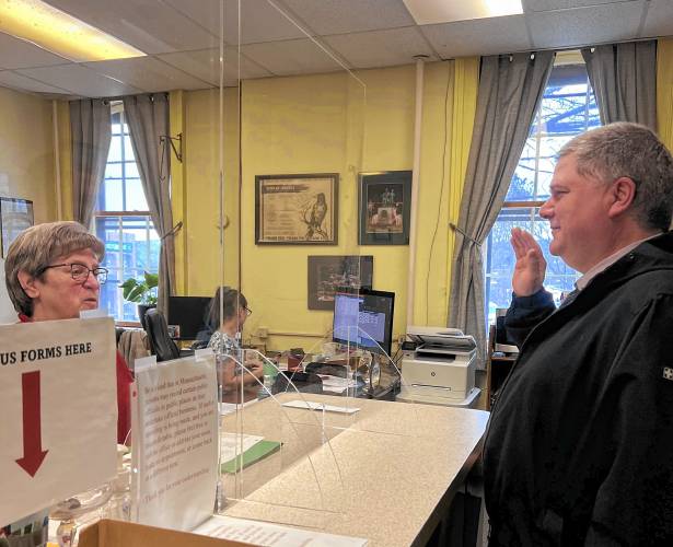 Michael Bates is sworn as an Orange Selectboard member by Town Clerk Nancy Blackmer on Tuesday morning. Bates defeated incumbent Patricia Lussier, 161 to 68, in a write-in campaign for a three-year seat. Michael Bates is sworn as an Orange Selectboard member by Town Clerk Nancy Blackmer on Tuesday morning. Bates defeated incumbent Patricia Lussier, 161 to 68, in a write-in campaign for a three-year seat.