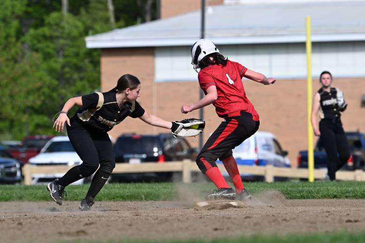 Pioneer’s Laylah Goulston tags Athol’s Kaya Stinehart over runs second in Northfield on Tuesday. 