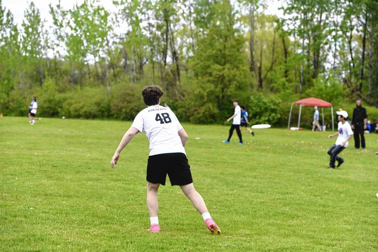 Amherst’s Ty Thomas-Paquin makes a pass against Deerfield Academy in the Four Rivers Ultimate Tournament in Greenfield Saturday.