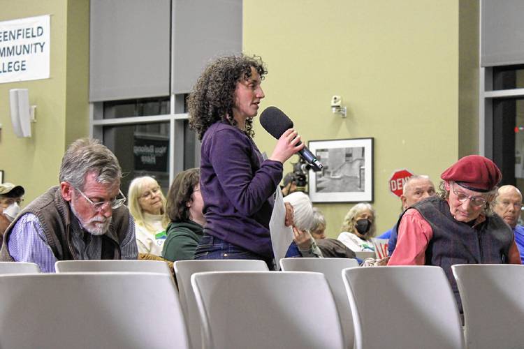 Connecticut River Conservancy Massachusetts River Steward Nina Gordon-Kirsch speaks during a public hearing on the state Department of Environmental Protection’s draft water quality certification for FirstLight Hydro Generating Co. at Greenfield Community College on Wednesday. To the left sits American Rivers Northeast Regional Director Andrew Fisk, and to the right, Nolumbeka Project Senior Advisor Joe Graveline, who is of Cherokee and Abenaki descent.