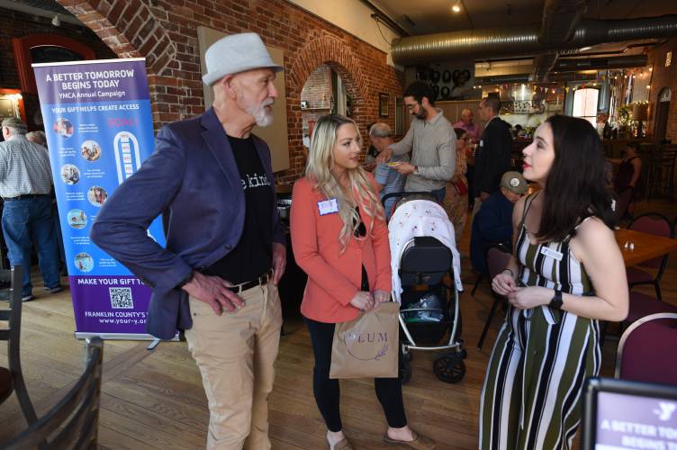 Grady Vigneau, CEO of Franklin County’s YMCA, talks with Jessye Deane, executive director of the Franklin County Chamber of Commerce, and YMCA exercise trainer Katie Alexander at the YMCA’s annual fundraising campaign kickoff at the Hawks & Reed Performing Arts Center in Greenfield in 2023.