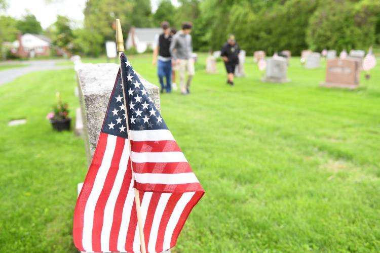 Members of Frontier Regional School’s National Honor Society chapter helped veterans place flags at Brookside Cemetery in South Deerfield on Wednesday morning.